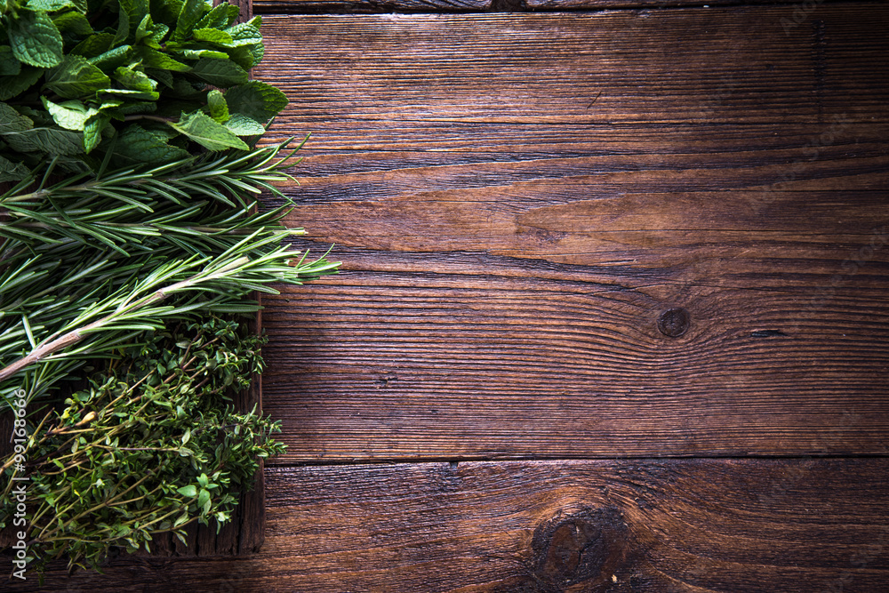 Fototapeta premium Fresh aromatic herbs on wooden background