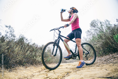 Woman drinking water on a bicycle