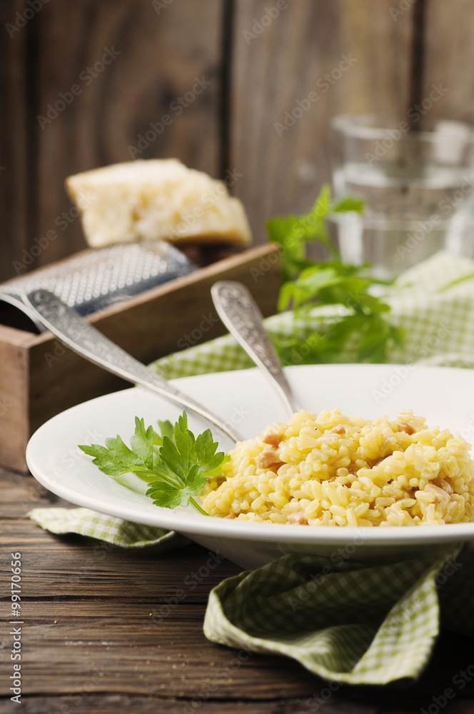 Italian traditional risotto with saffron and ham