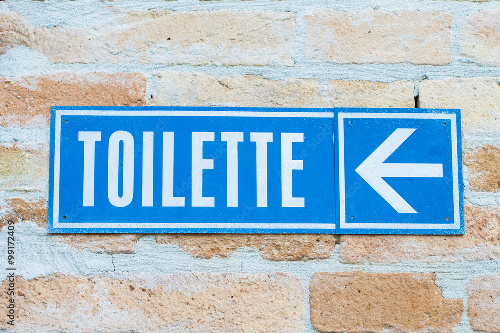 Toilet signboard with indication on a wall Toilet signboard with indication on a wall