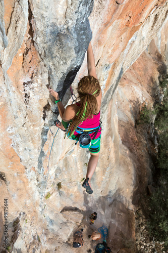 Female Climber Trying to keep Hold in last Effort to avoid deep fall down