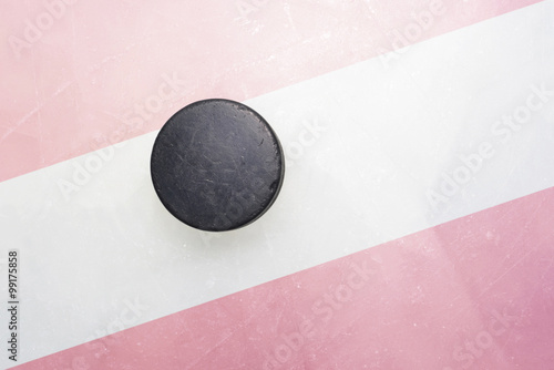 old hockey puck is on the ice with austria flag