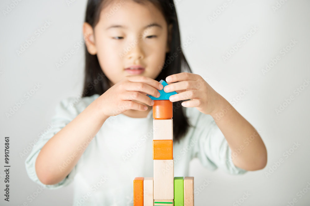 little Asian girl playing colorful wood blocks little Asian girl playing colorful wood blocks
