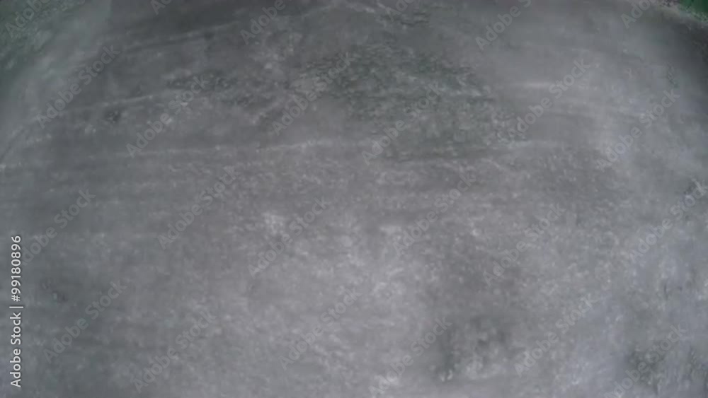 Man scraping ice from car window in the morning Man scraping ice from car window in the morning