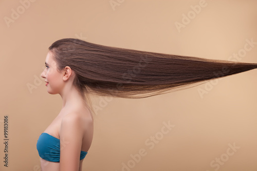 Attractive slim girl is boasting of her hairstyle