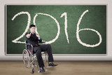 Happy disabled businessman with numbers 2016