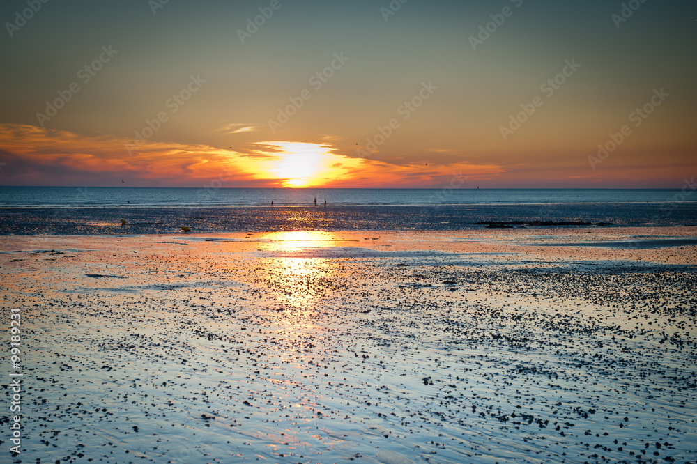 Sunset landscape on the beach during low tide