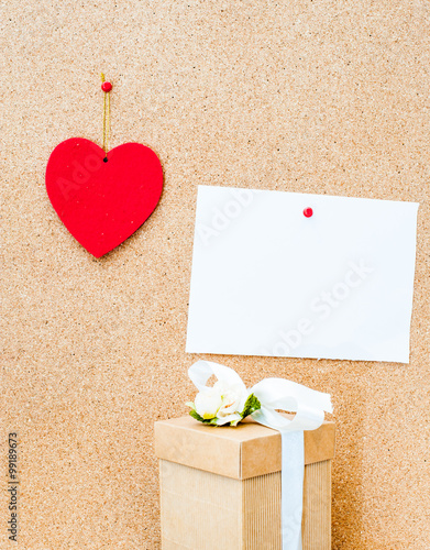 Valentine's day heart, gift box and white empty card on wooden b