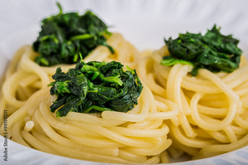 Pasta with spinach on white plate Pasta with spinach on white plate