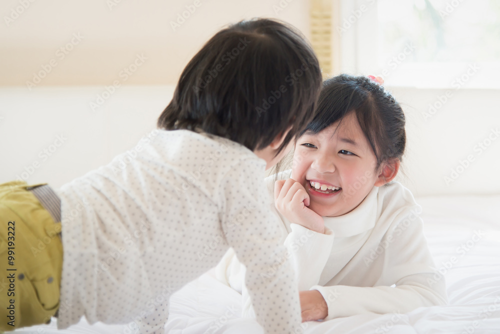 asian children lying on white bed asian children lying on white bed