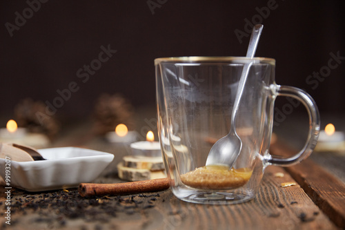 Obraz na plátně Brown sugar and honey in a tea glass and cinnamon and orange sli