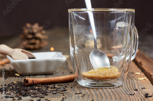 Brown sugar and honey in a tea glass and cinnamon and orange sli