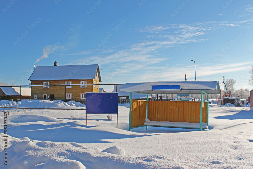 Naklejka premium Swept snow bus stop in the cold winter