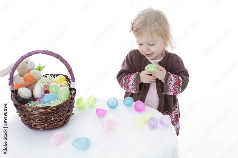 Little girl playing with Easter eggs, isolated on white background Little girl playing with Easter eggs, isolated on white background