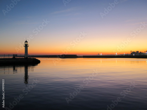 Lighthouse in the port at sunset
