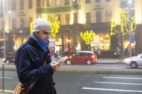 Young man outdoors with mobile phone