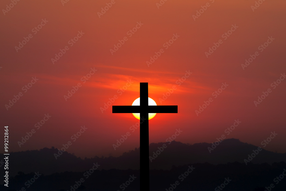 Silhouette of cross over sunset background