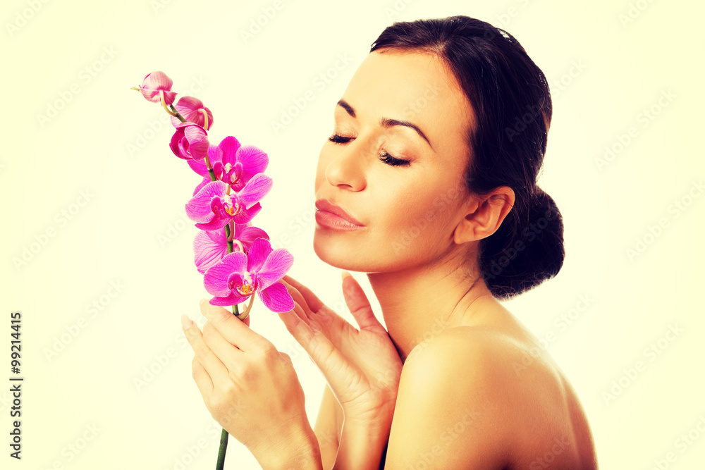 Fototapeta premium Topless woman with purple orchid branch