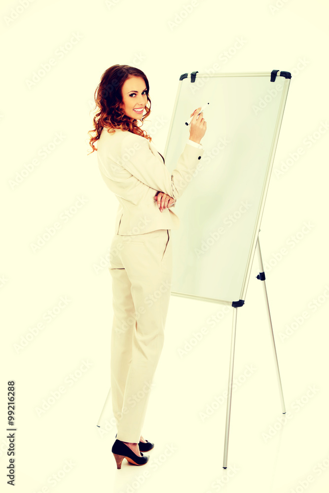 Business woman writing on flipchart. Business woman writing on flipchart.