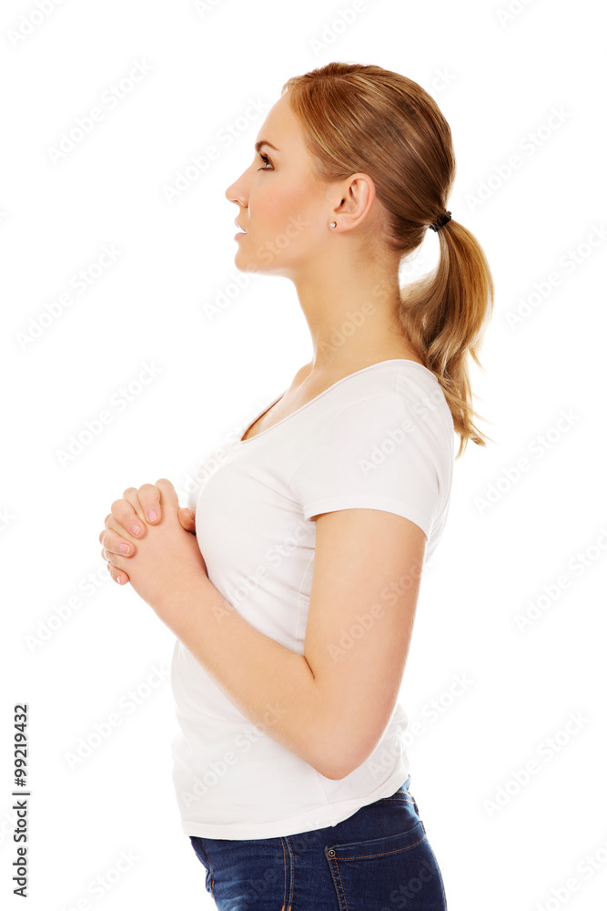 Young woman praying - religion concept Young woman praying - religion concept