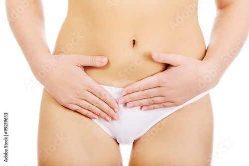 Young woman with hands on belly-stomach ache