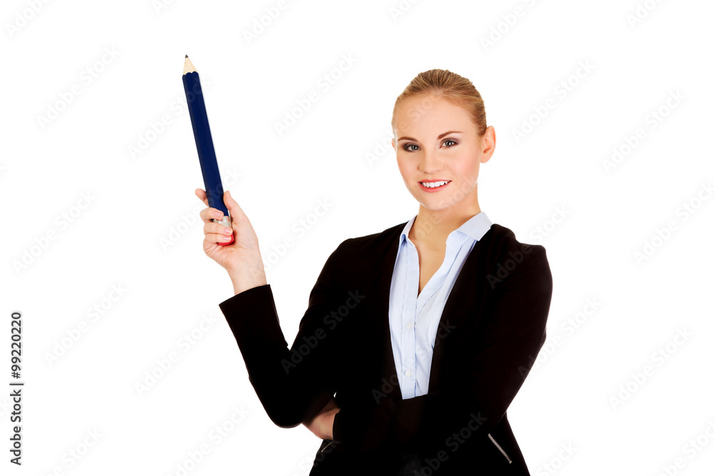 Business woman pointing for copyspace or something with huge pen Business woman pointing for copyspace or something with huge pen
