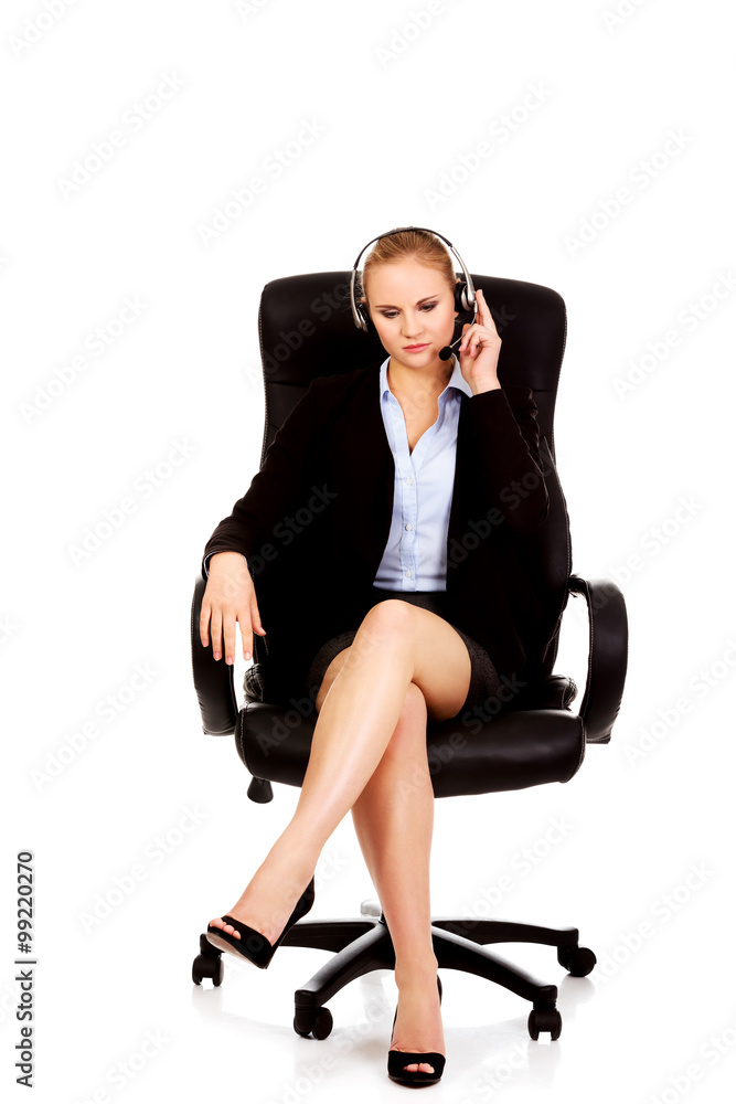 Young woman helpline operator is trying to hear something headphones Young woman helpline operator is trying to hear something headphones