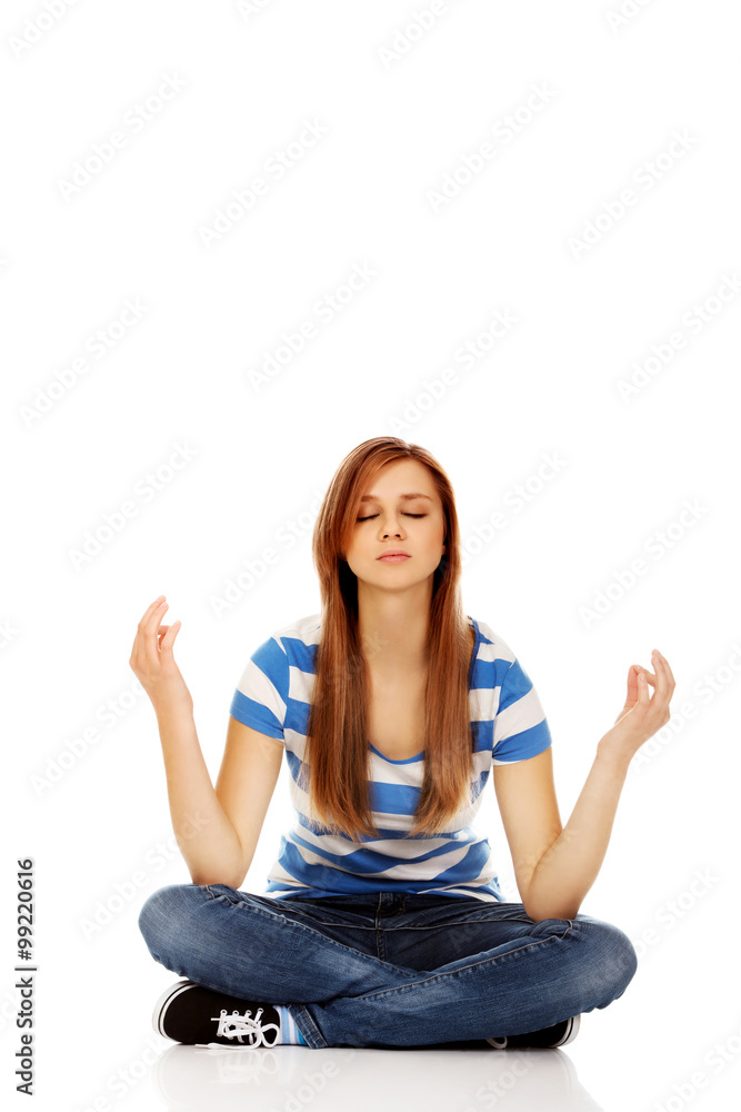 Teenage woman meditation on the floor Teenage woman meditation on the floor