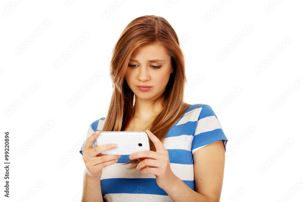 Teenage woman using her smartphone Teenage woman using her smartphone