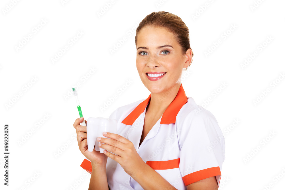 Young dentist woman with toothbrush and tooth model Young dentist woman with toothbrush and tooth model