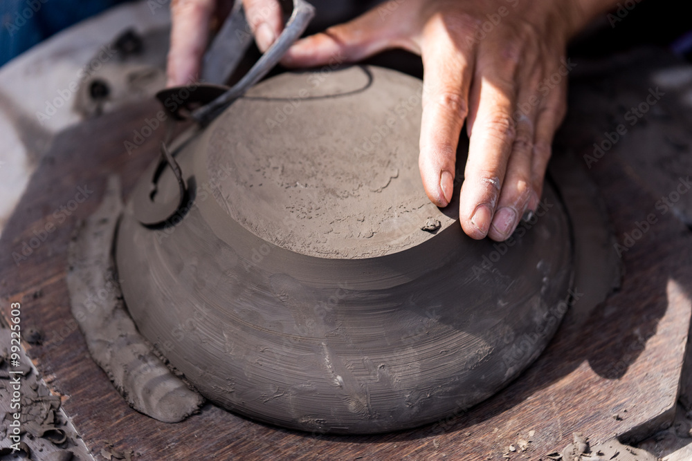 Hands working with clay on pottery wheel Hands working with clay on pottery wheel