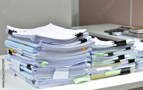 Pile of documents on desk at workplace