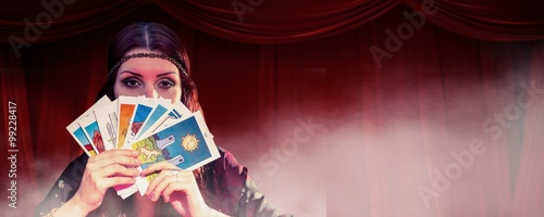 Fortune teller hiding mouth with cards photo