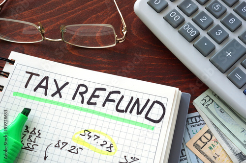 Canvas Print Notebook with  tax refund sign on a table. Business concept.