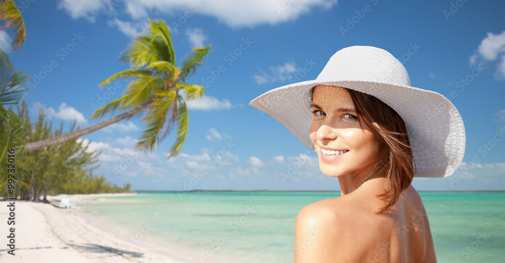 happy young woman in sunhat over summer beach