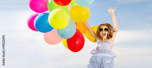 happy jumping girl with colorful balloons