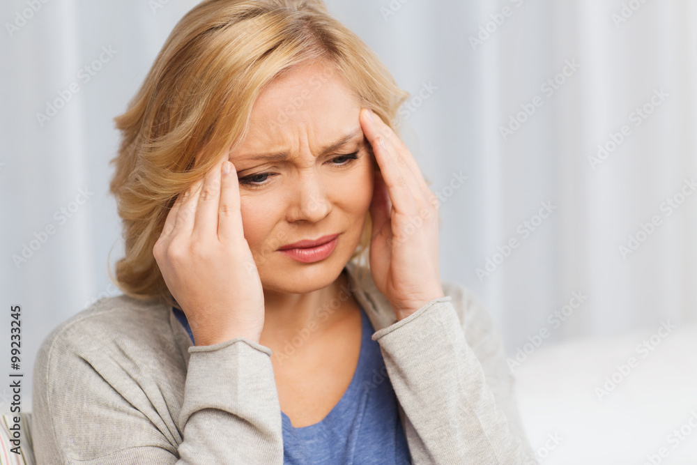 unhappy woman suffering from headache at home unhappy woman suffering from headache at home