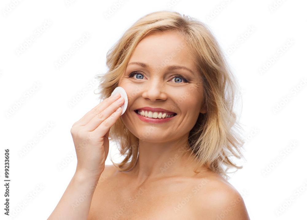 happy woman cleaning face with cotton pad happy woman cleaning face with cotton pad