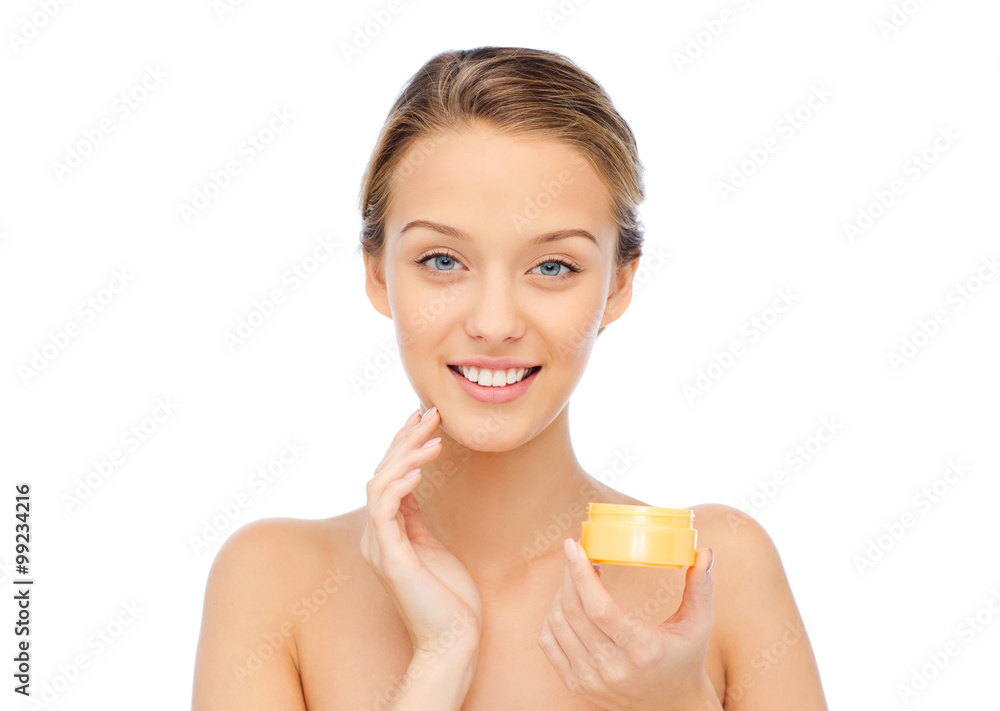 happy young woman applying cream to her face happy young woman applying cream to her face