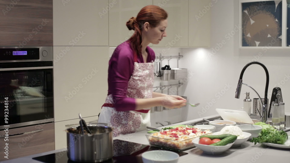 The woman in the kitchen preparing sauce The woman in the kitchen preparing sauce