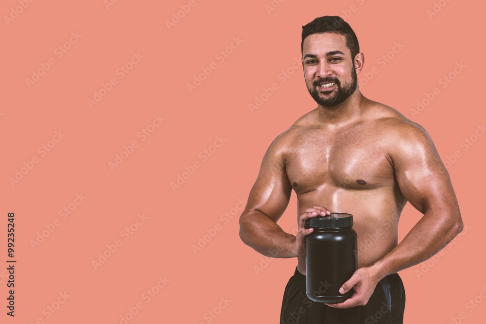 Fototapeta premium Composite image of muscular man with protein powder
