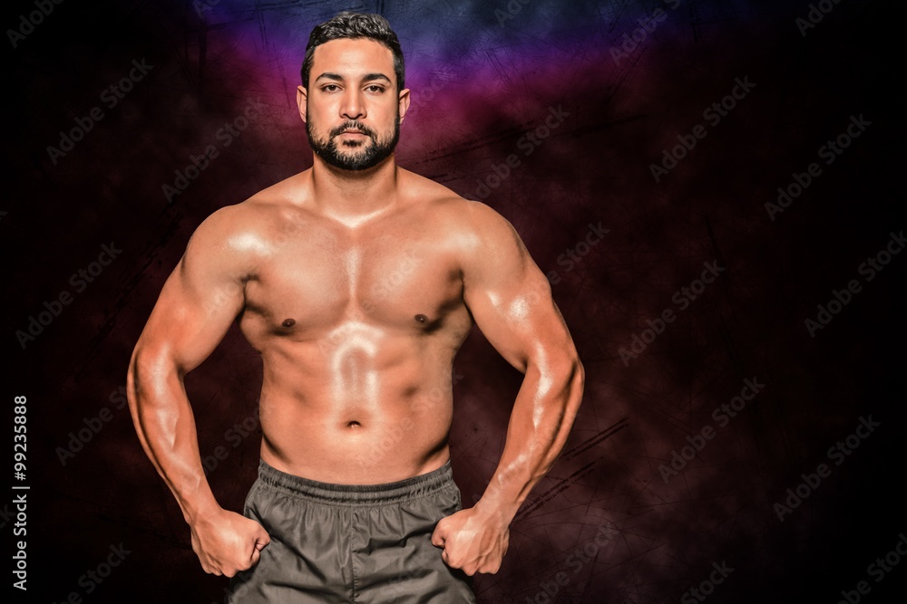 Fototapeta premium Composite image of portrait of a bodybuilder man flexing muscles