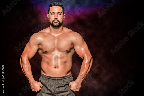 Composite image of portrait of a bodybuilder man flexing muscles