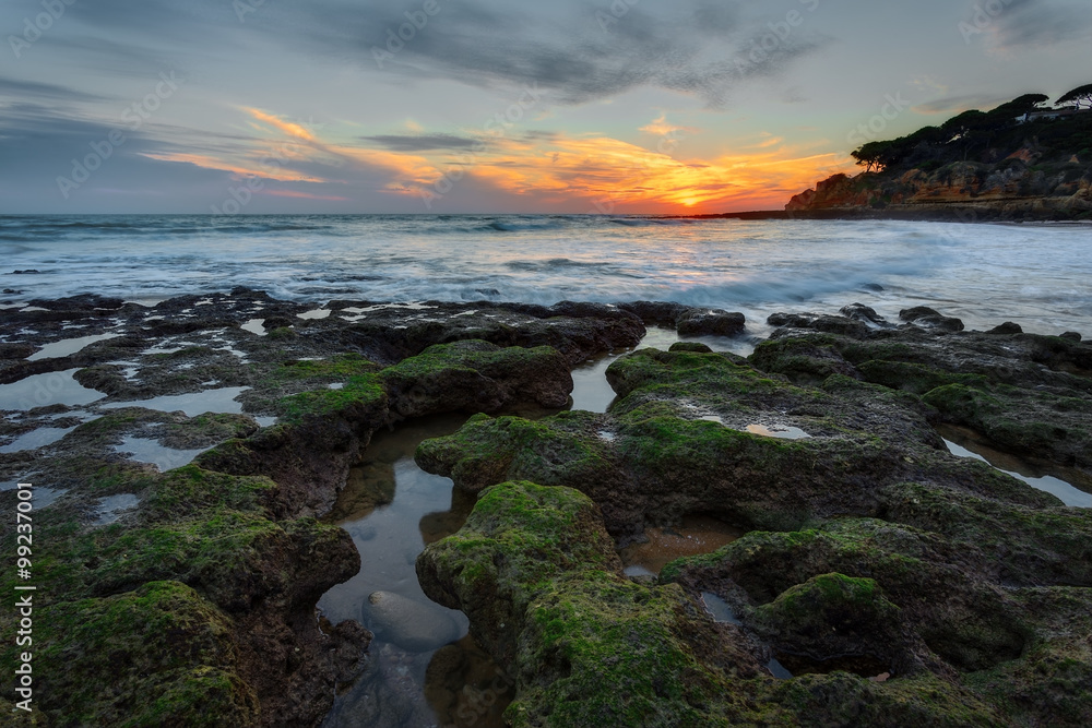 Magical sunset at sea in Portugal. Stones beautiful shape in the foreground. Magical sunset at sea in Portugal. Stones beautiful shape in the foreground.