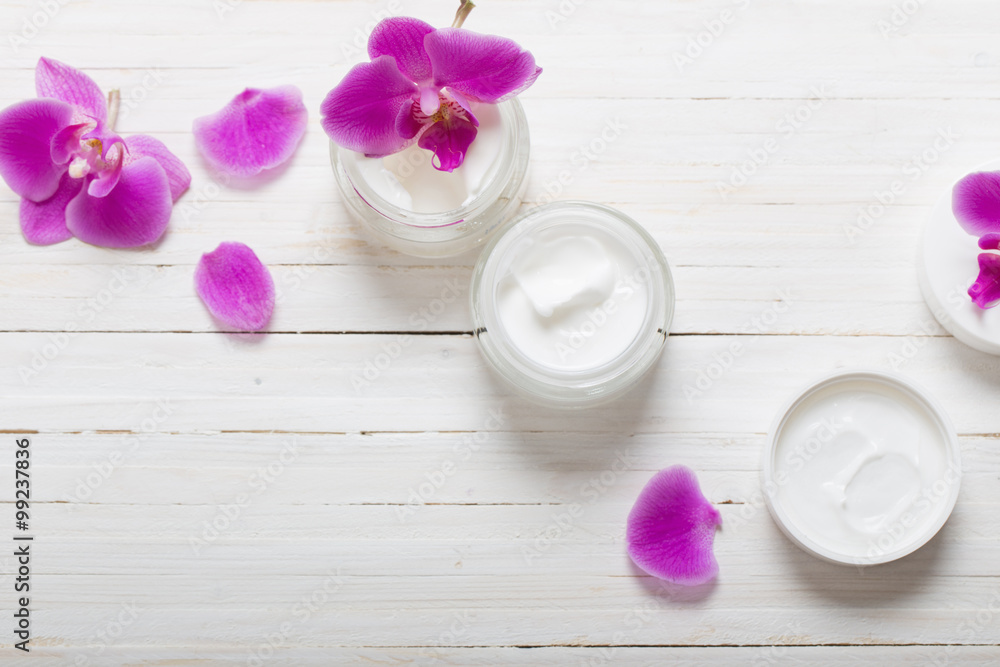 cream and pink orchid flowers on white wooden background