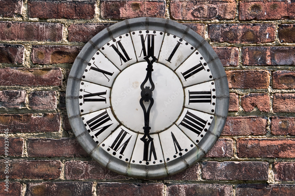 Vintage retro style clock on a red brick wall