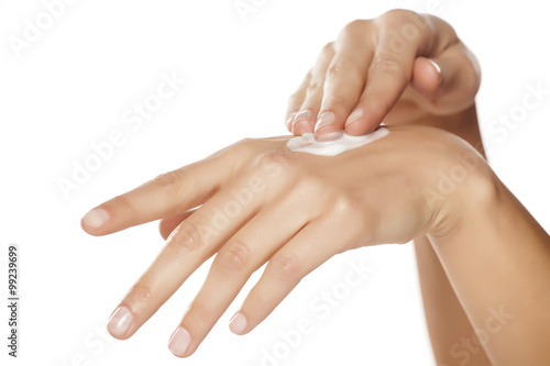 Woman applying hand cream photo