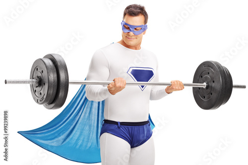 Young superhero exercising with a barbell