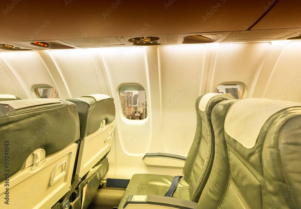Fototapeta premium Airplane window with view on New York City. Holiday and travel c
