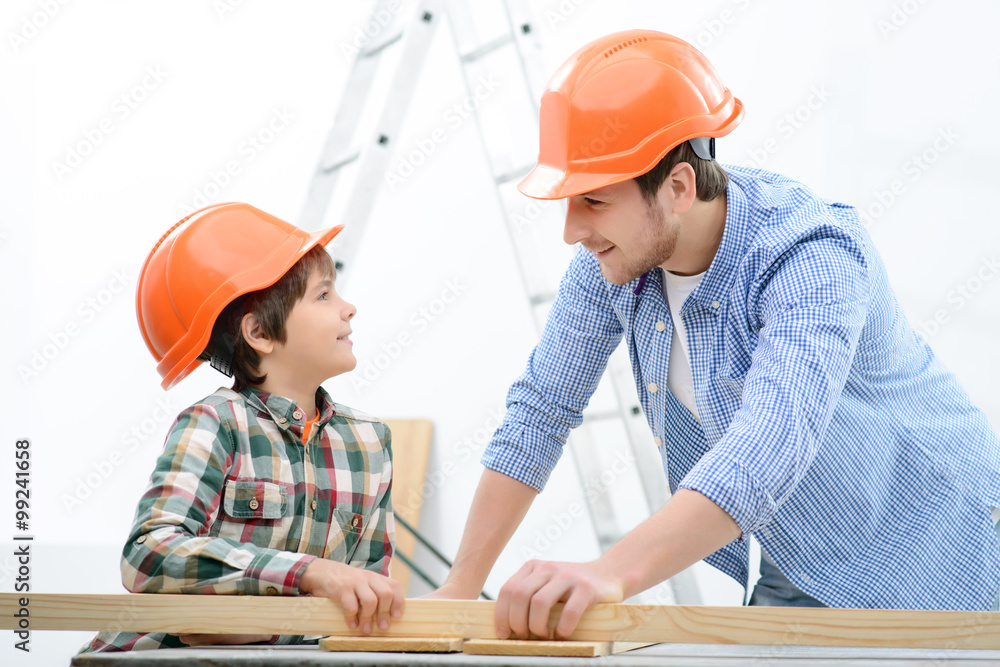 Cheerful father and son making renovation Cheerful father and son making renovation
